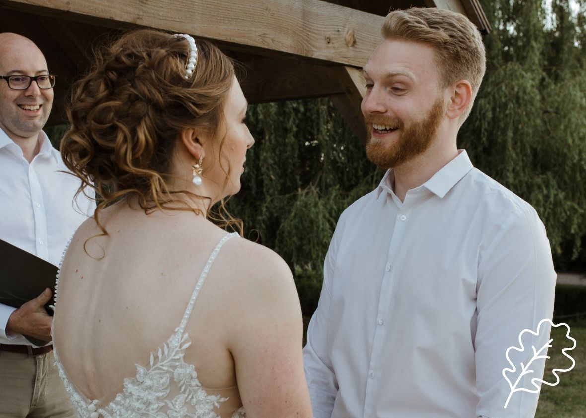Couple smiling and renewing their vows outside for mobile